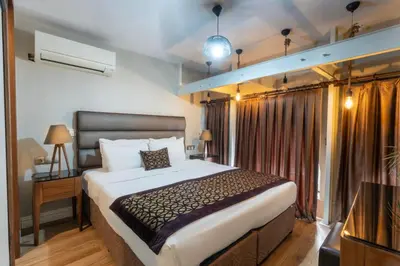 a bedroom with a large bed and a window at 6 Apartment Galata in Istanbul