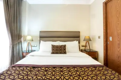 a bedroom with a large bed and two lamps at 6 Apartment Galata in Istanbul