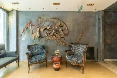a living room with two chairs and a painting at 6 Apartment Galata in Istanbul