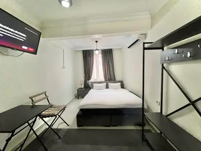 a small room with a bed and a window at Mr Miller Suite in Istanbul