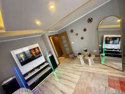 a living room with a tv and a mirror at Dilaver-Apart in Istanbul