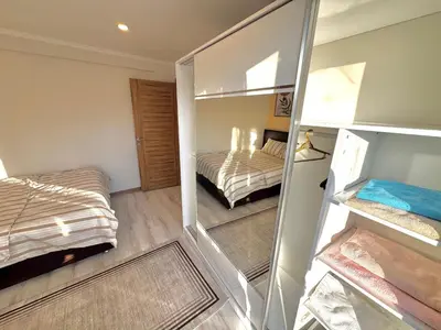 a small bedroom with a bed and a mirror at Dilaver-Apart in Istanbul