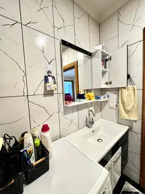 a small kitchen with a sink and a mirror at Dilaver-Apart in Istanbul