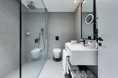 a bathroom with a shower and a toilet and a sink at INVENTIST Hotel Sports Academy Istanbul in Istanbul