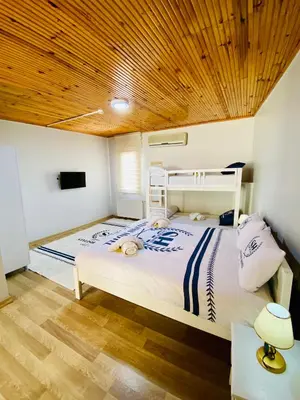a bedroom with a white bed with a wooden ceiling at Stylish Hotel Old City in Istanbul