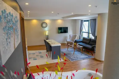 a living room with a couch and a table at Parla Suite Hotel in Esenyurt
