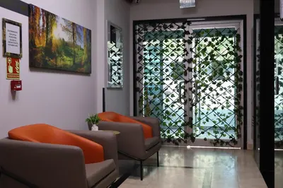 a waiting room with two chairs and a window at HOME PLUS Hotel in Istanbul
