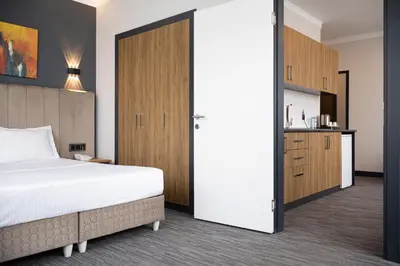 a bedroom with a bed and a sliding door at HOME PLUS Hotel in Istanbul