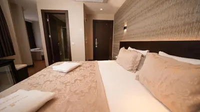 a bedroom with a large bed with white sheets and pillows at Bellezza Hotel in Istanbul