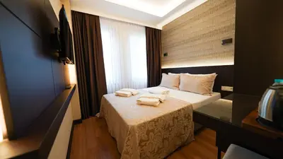 a hotel room with a bed with two towels on it at Bellezza Hotel in Istanbul
