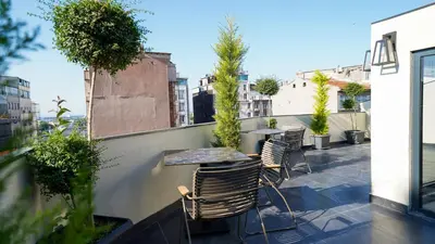 a patio with tables and chairs on a balcony at Bellezza Hotel in Istanbul