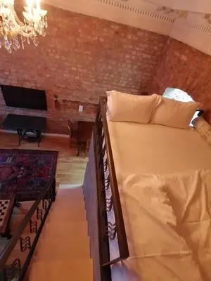 a bedroom with two bunk beds and a brick wall at Casa 1899 in Istanbul