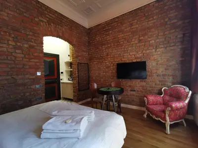 a bedroom with a bed and a brick wall at Casa 1899 in Istanbul