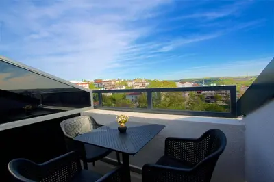 a table and chairs on a balcony with a view at Days Inn by Wyndham Istanbul Arnavutkoy in Istanbul