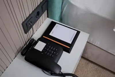 a desk with a phone and a tablet on it at Days Inn by Wyndham Istanbul Arnavutkoy in Istanbul