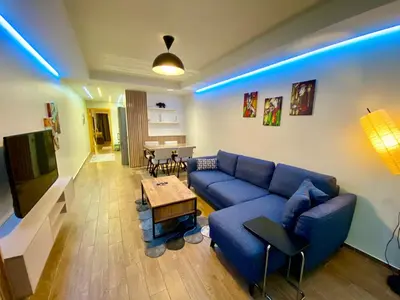 a living room with a blue couch and a table at Unique/Cosy flat near Taksim/Nişantaşı in Istanbul