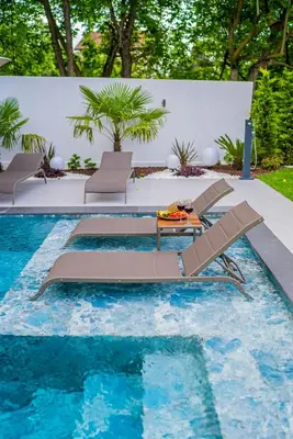 a pool with two lounge chairs and a table at Terra House Sapanca in Sapanca