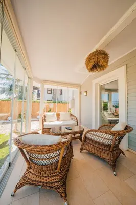 a living room with wicker chairs and a couch at Terra House Sapanca in Sapanca