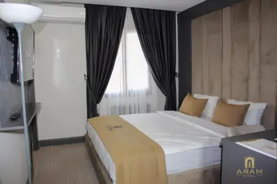 a bedroom with a large bed with a window at Aram Otel Business & Luxury in Istanbul