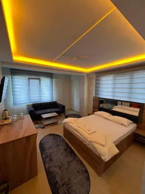 a bedroom with a large bed and a couch at NEAR SUITES in Istanbul