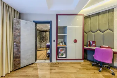 an office with a purple chair and a sliding door at Heaven Premium Hotel Restaurant & Airport Shuttle in Arnavutköy