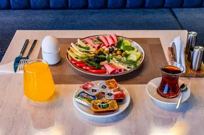 a table with a tray of food and a plate of food at Heaven Premium Hotel Restaurant & Airport Shuttle in Arnavutköy
