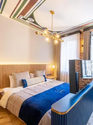 a bedroom with a large bed and a television at Hotel Balo in Istanbul