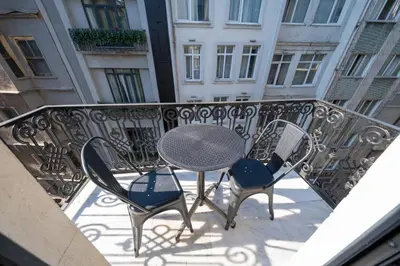 a table and chairs on a balcony with a building at Hotel Balo in Istanbul
