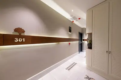 a hallway with white walls and a clock on the wall at Hotel Balo in Istanbul