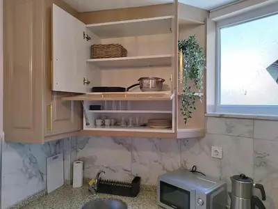 a kitchen with white cabinets and a window at Cozy Home Next to Green Mosque in Yıldırım