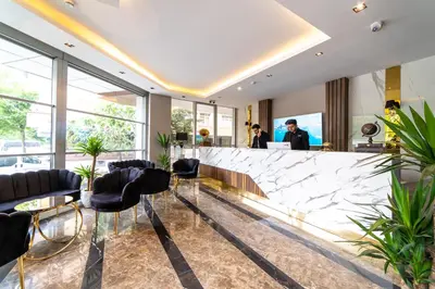 a lobby with black chairs and a marble counter at Garden Room Suit Hotel in Istanbul