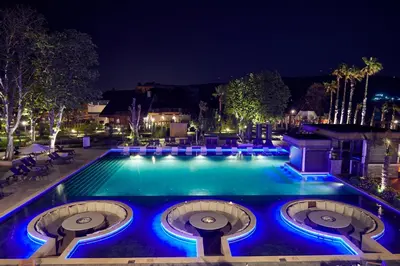 a swimming pool at night with blue lights at Parmos Otel in Erdek