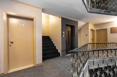 a hallway with stairs and a yellow door at BURSA LOYAL CiTY HOTEL in Bursa