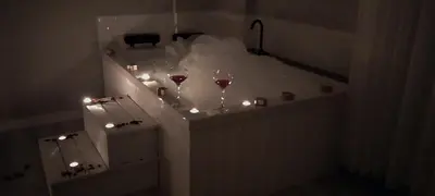 a room with two glasses of wine and lights at Begonvil Konaklama in Sapanca