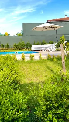 an umbrella sitting next to a swimming pool at Begonvil Konaklama in Sapanca