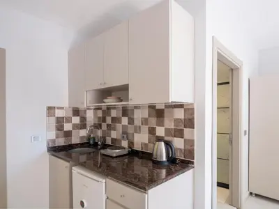 a kitchen with white cabinets and a counter top at The Red Tent Suite 23 in Istanbul