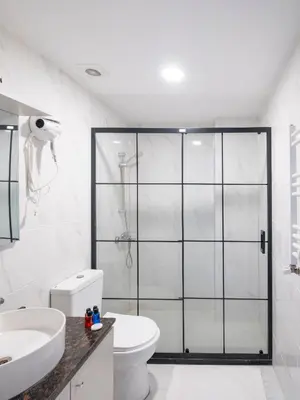 a bathroom with a toilet and a glass shower at The Red Tent Suite 23 in Istanbul