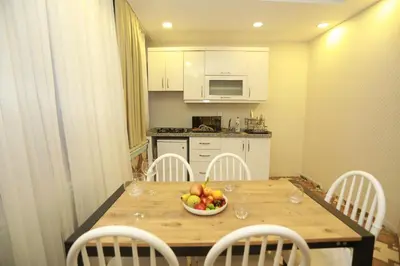 a kitchen with a table with a bowl of fruit on it at IMMORTELLE HOTEL lord sophiha in Istanbul