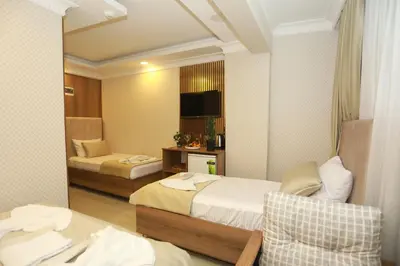 a hotel room with two beds and a television at IMMORTELLE HOTEL lord sophiha in Istanbul