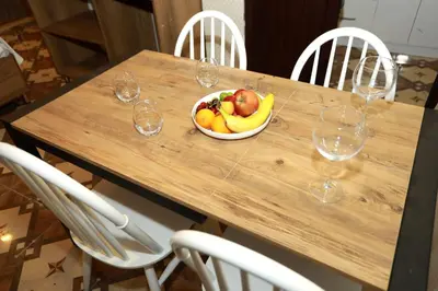a bowl of fruit on a wooden table with wine glasses at IMMORTELLE HOTEL lord sophiha in Istanbul