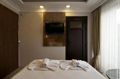 a bedroom with a bed with towels on it at IMMORTELLE HOTEL lord sophiha in Istanbul