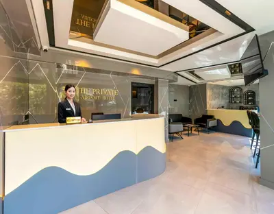 a woman standing behind a counter in a office at The Private Airport Hotel in Istanbul