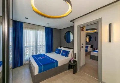 a bedroom with a bed and a large window at The Private Airport Hotel in Istanbul
