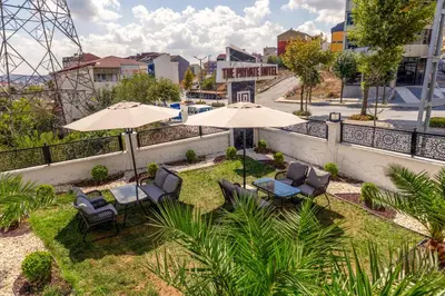 a patio with chairs and umbrellas on a balcony at The Private Airport Hotel in Istanbul