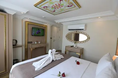 a bedroom with a white bed with flowers on it at Blue Zerzevan Konak Hotel in Istanbul