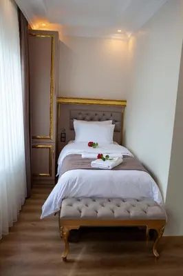 a bedroom with a bed with flowers on it at Blue Zerzevan Konak Hotel in Istanbul