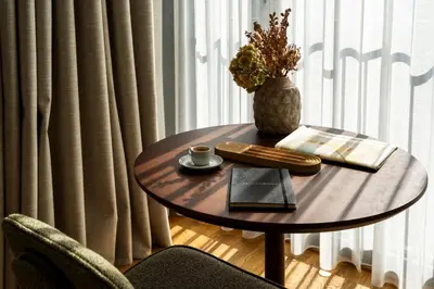 a table with a cup of coffee and a book at Ando Living Taksim House in Istanbul
