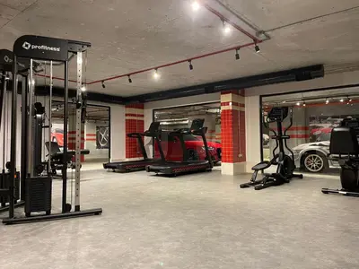 a garage with a gym with treadmills and cars at Ando Living Taksim House in Istanbul