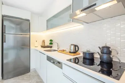 a kitchen with a stove and a refrigerator at Mayar Residence Hotel in Istanbul