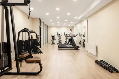 a gym with tread machines and a man in the background at Mayar Residence Hotel in Istanbul